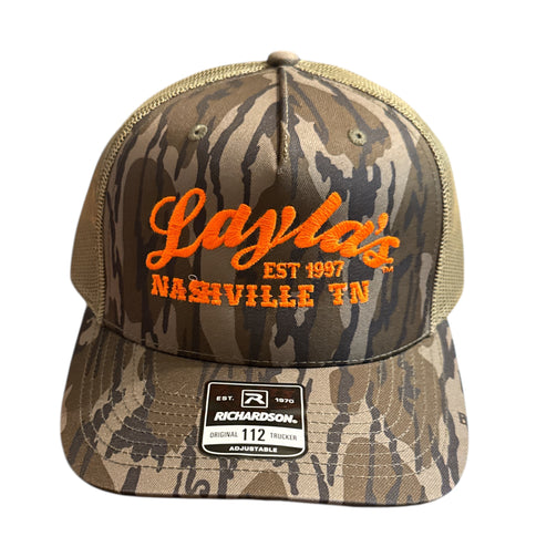 Camouflage cap with orange text on a white background