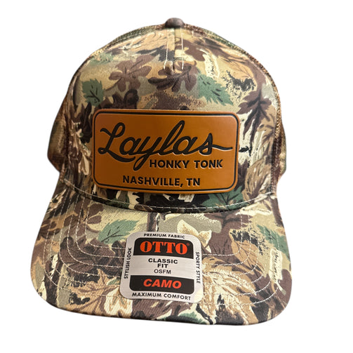 Camouflage cap with a brown leather patch and 'Laylas Honky Tonk' branding on a white background.